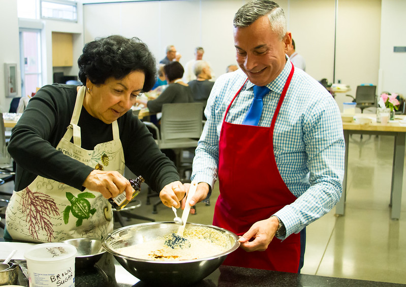 Woman mixing flavoring into a mixture in a bowl.