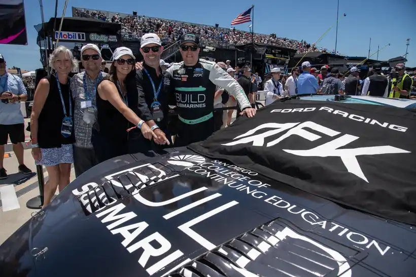 NASCAR Cup Series champion Brad Keselowski (right) with Brad Dorschel (second from right)