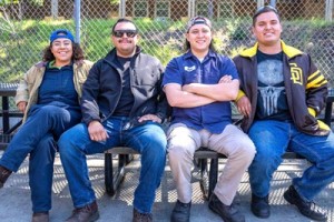 4 welding students sitting on a bench