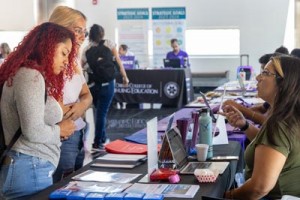 students at an outreach table