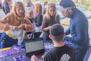 students at an outreach table
