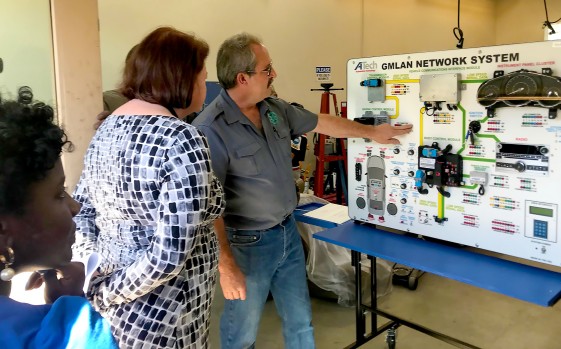 Toni Atkins getting a demo on auto network systems. Auto shop
