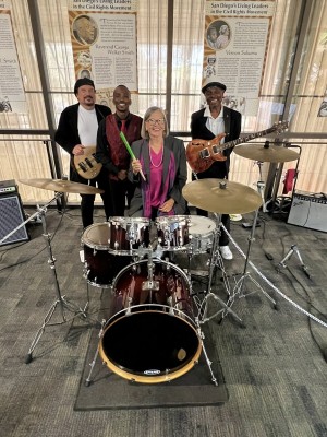 SDCCE Interim President Kay Faulconer Boger, Ed.D. takes photo with CEO’s Rhythm Section during her farewell event.