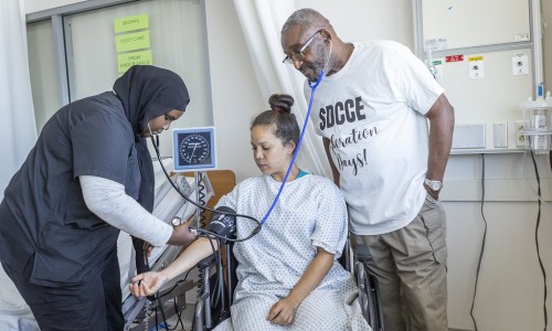 Professor Kenny Parker (far right) leads students through CNA curriculum 
