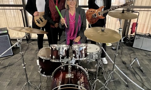 SDCCE Interim President Kay Faulconer Boger, Ed.D. takes photo with CEO’s Rhythm Section during her farewell event.